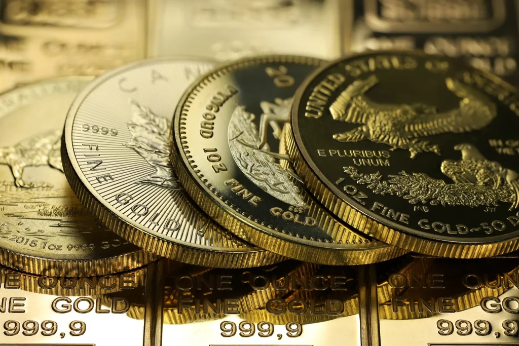 B2Gold: The Stars Are Aligning 4 different 1 ounce gold bullion coins on a layer of gold ingots