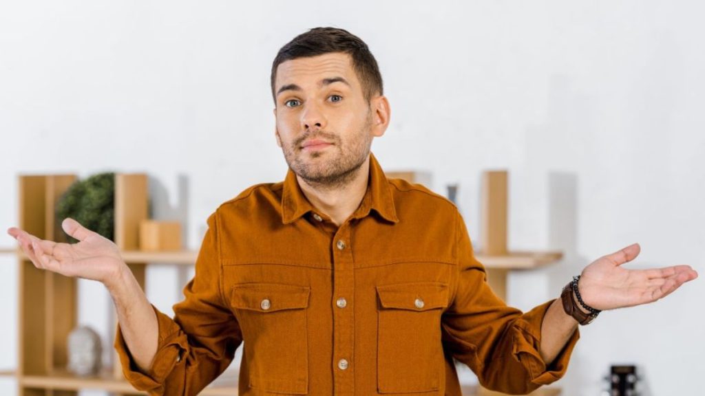 Short-bearded man giving the "who knows' body language MSN