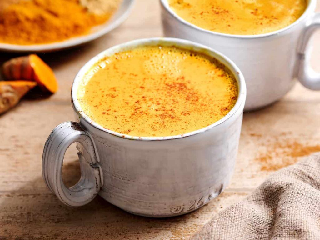 Golden milk in a white mug.