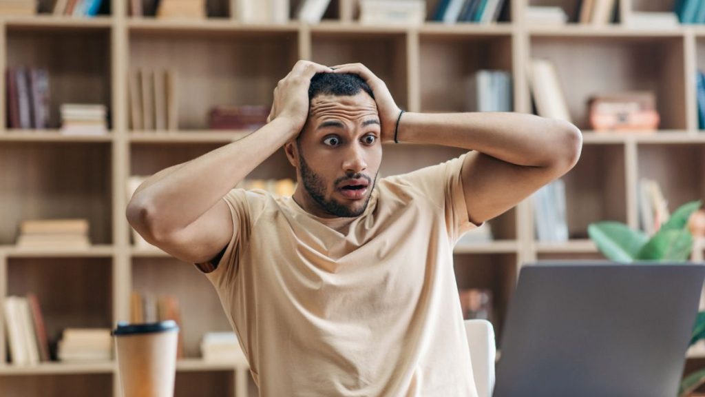 Man so shock looking at his laptop MSN