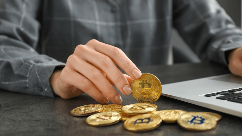 How Is Cryptocurrency Taxed? Tax Guide for 2025 Businesswoman With Bitcoins and Laptop on the Table Stock