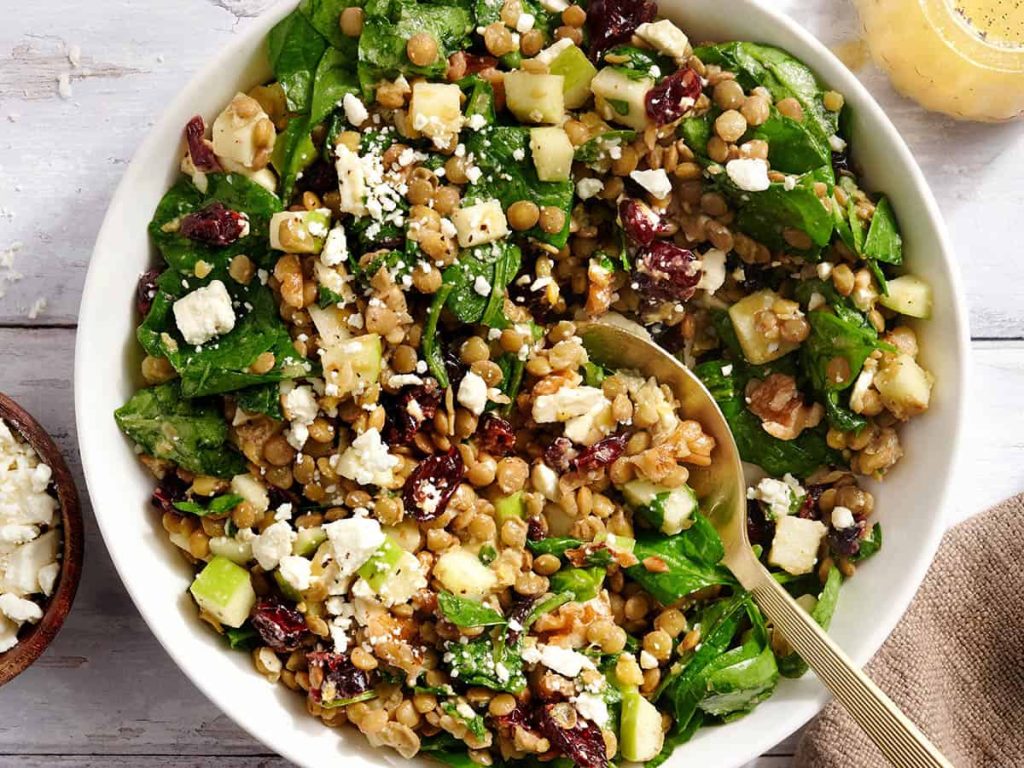 Lentil and Cranberry Salad – Budget Bytes Overhead view on a cranberry and lentil salad in a bowl with a spoon.