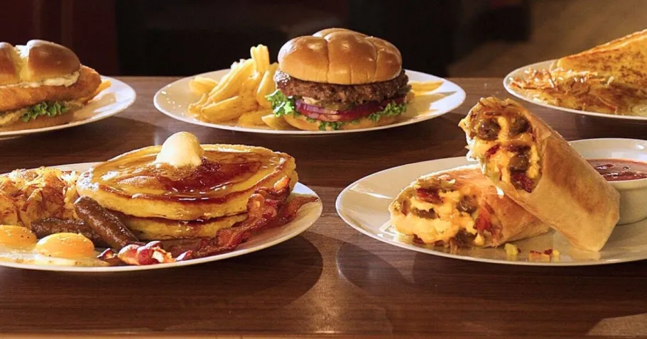 NEW Denny’s Slammin’ Meal Deals Start at Just $5.99 Several Plates of meals on a table including burgers, pancakes, and more