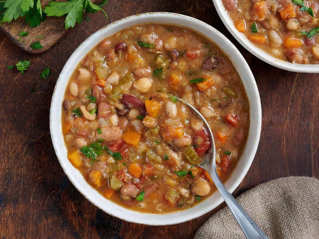 15 Bean Soup Recipe – Budget Bytes Overhead view of 15 bean soup in a bowl with a spoon.