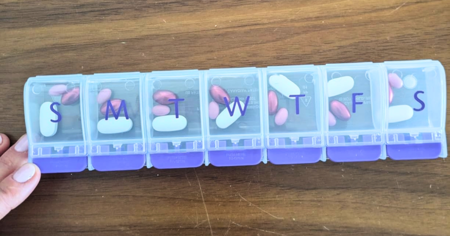 Daily Pill Organizer Only $2 Shipped on Amazon ezy dose pill organizer with purple tabs filled with pills on table
