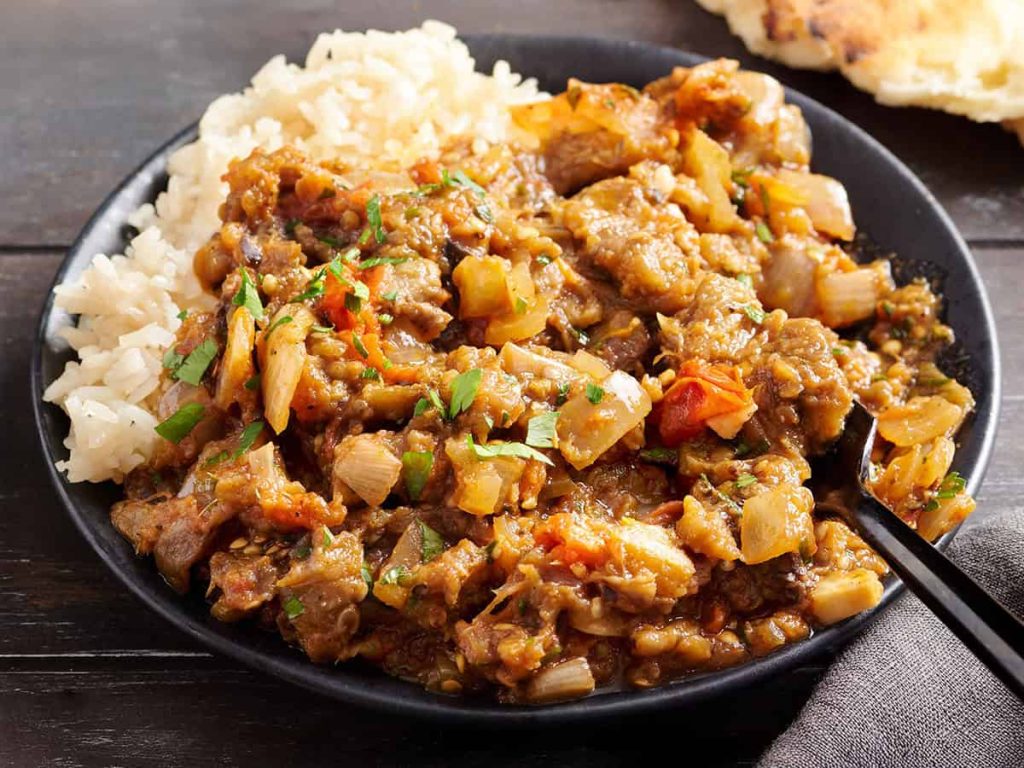 Eggplant Curry – Budget Bytes Side view of eggplant curry on a plate with rice.