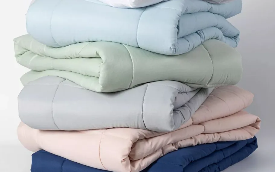 Macy’s Comforters & Sets from $19.99 (Reg. $130) rolled up comforters in different colors