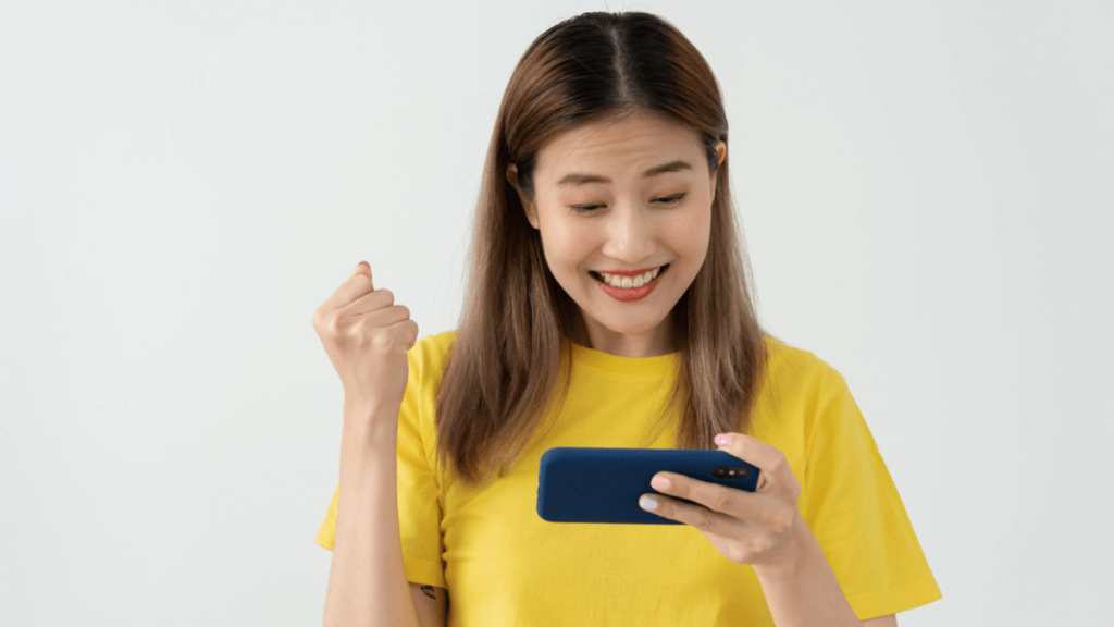 Top 13 Isekai Manga Choices You Need To Watch Excited young woman watching on her phone MSN