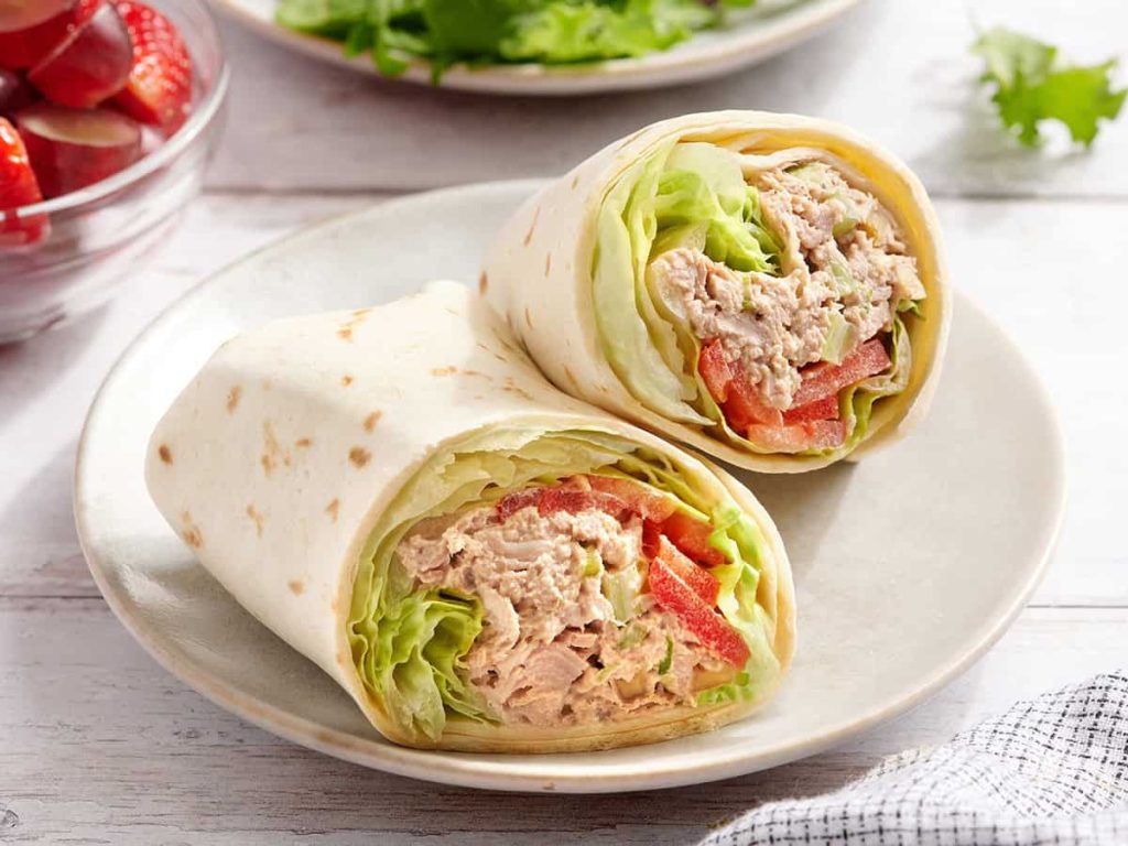 Tuna Wrap – Budget Bytes A tuna wrap sliced in half on a plate.