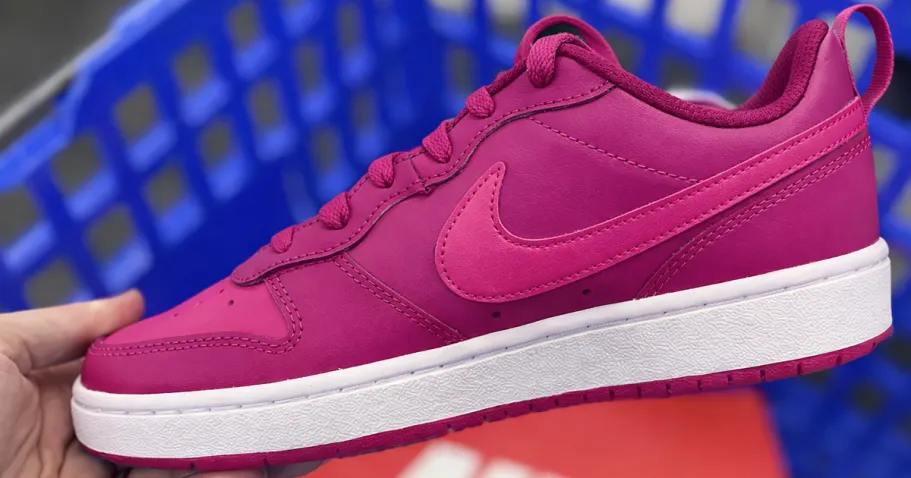 Don’t Miss Your Shot to Snag These Nike Dunks | Popular Styles from $44.97! hand holding up a magenta nike sneaker