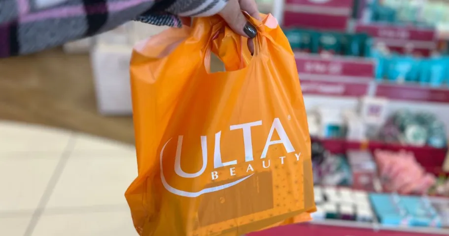 Grab The Best ULTA Sales & When They’re Happening hand holding ulta shopping bag in store
