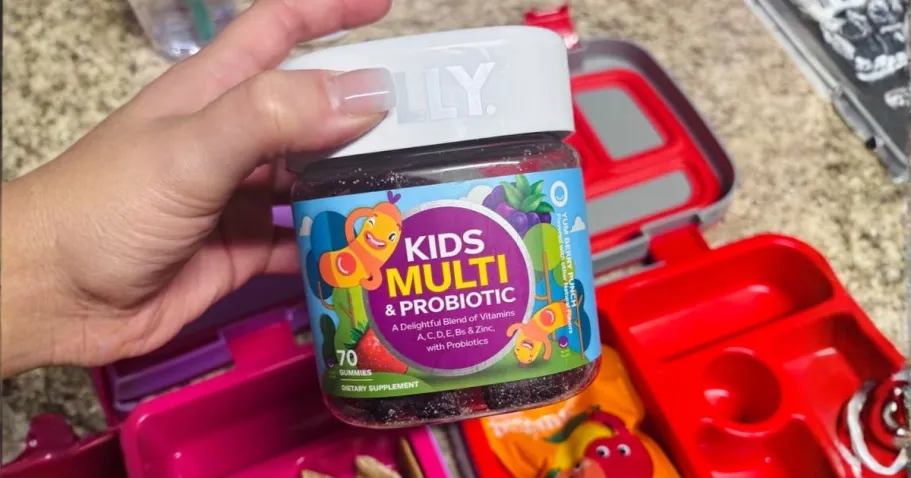 OLLY Kids Multivitamin & Probiotic Gummies 70-Count Only $9.87 Shipped on Amazon hand holding OLLY Kids Multivitamin & Probiotic Gummies 70-Count above lunch box