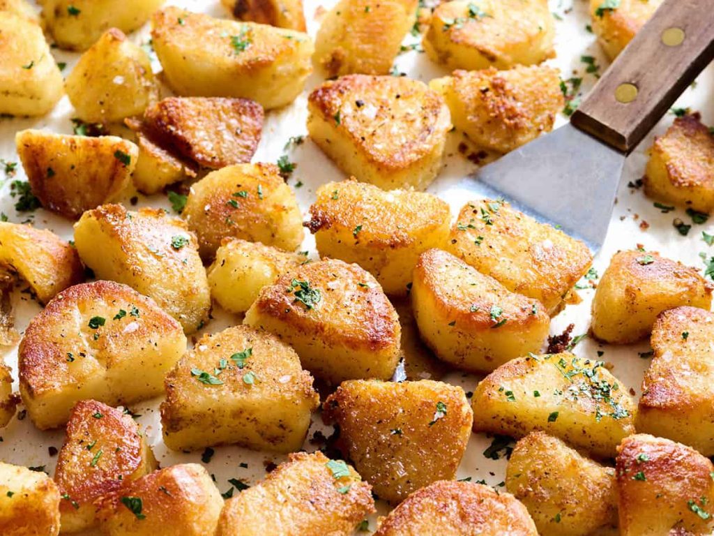 Oven Roasted Potatoes – Budget Bytes Oven roasted potatoes on a baking sheet with a spatula.