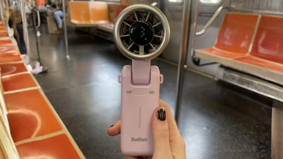 Portable 5-Speed Turbo Fan from $9 on Amazon (Reg. $19) a womans hand holding a personal fan