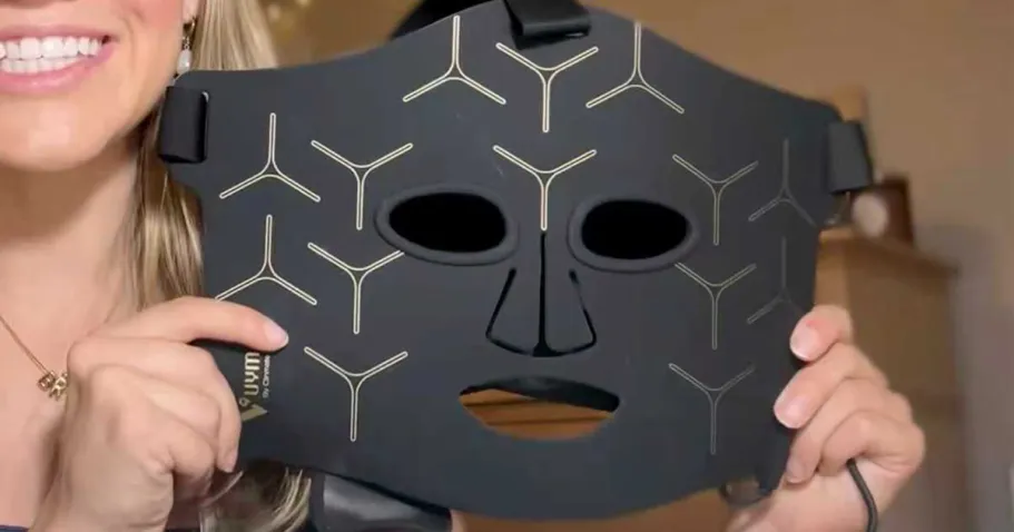 Red Light Therapy Mask Just $44.50 Shipped on Amazon | Targets Wrinkles & Pores woman holding red light therapy mask