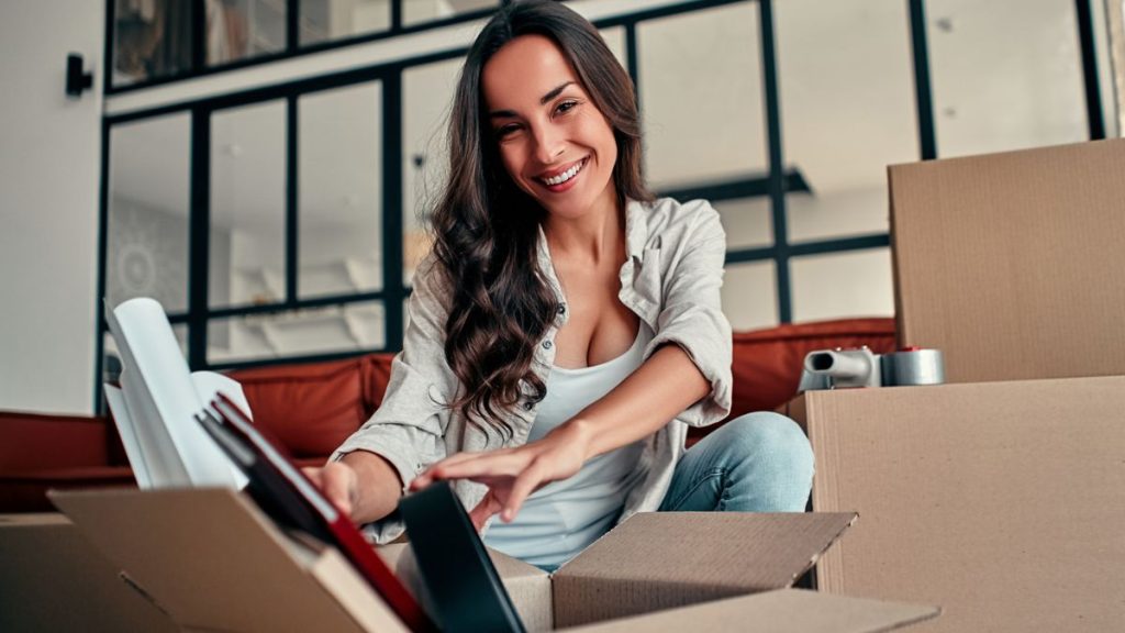 Smiling Woman Putting Things In A Box