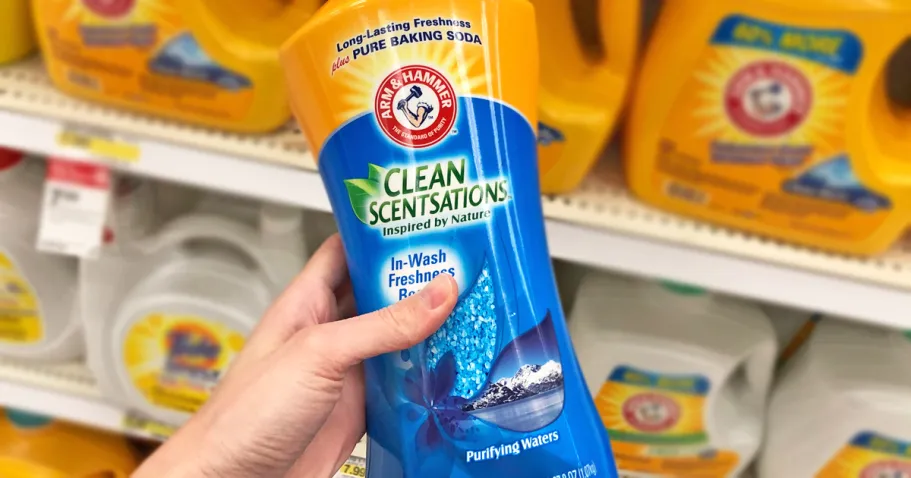Arm & Hammer Scent Booster Just $5.94 Shipped on Amazon (Reg. $11) hand holding a yellow and blue bottle of Arm & Hammer Clean Scensations Scent Booster in store