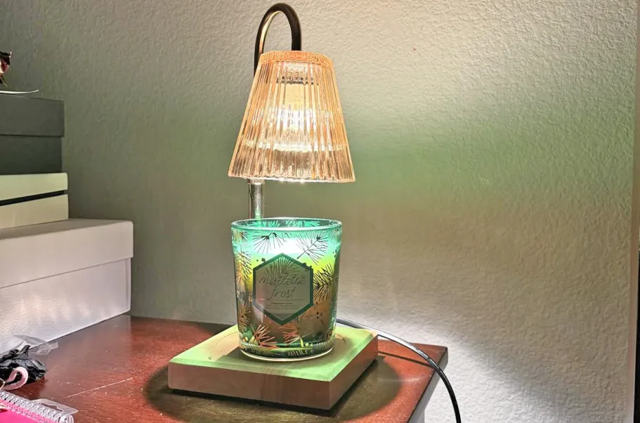 Candle Warmer Lamp w/ Timer Just $10.79 Shipped for Amazon Prime Members (Reg. $28) candle warmer lamp with a green candle on a side table