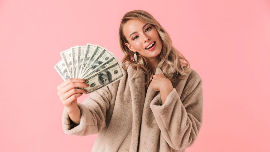 Smiling Blonde Woman Holding Money MSN