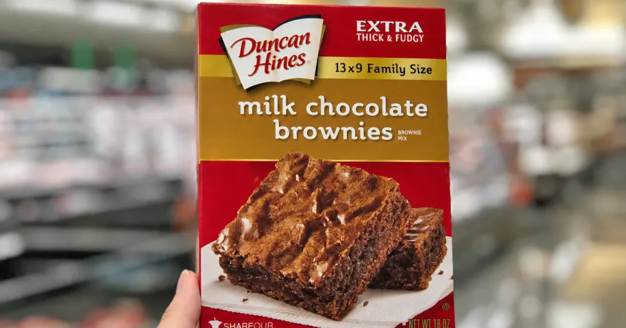 Duncan Hines Family Size Brownie Mix Only $1.37 Shipped on Amazon hand holding up a box of Duncan Hines Brownie Mix in store