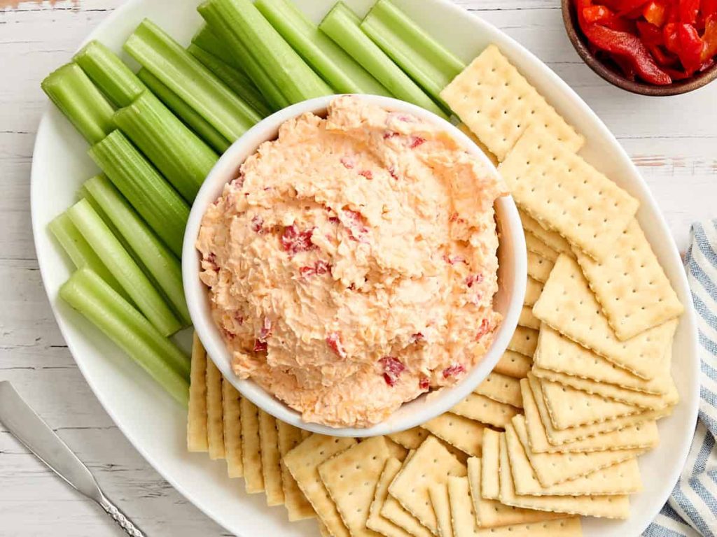 Pimento Cheese – Budget Bytes Overhead view of a bowl of pimento cheese with celery and crackers.