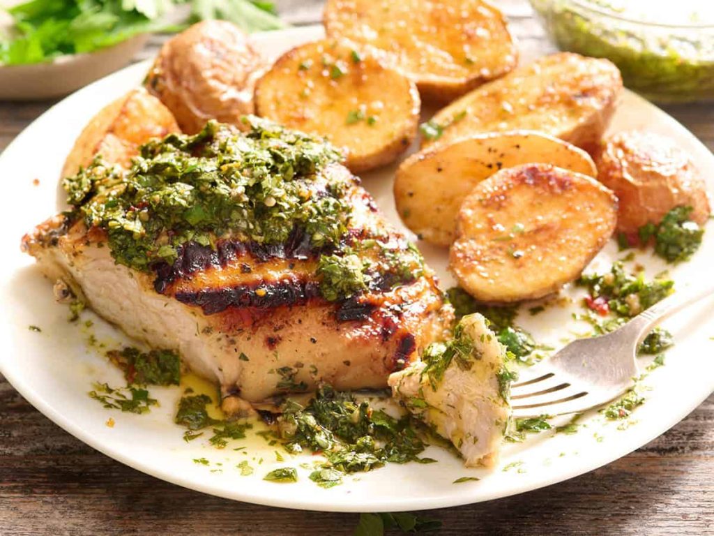Chimichurri Grilled Chicken – Budget Bytes Side view of chimichurri grilled chicken on a plate with roasted potatoes.