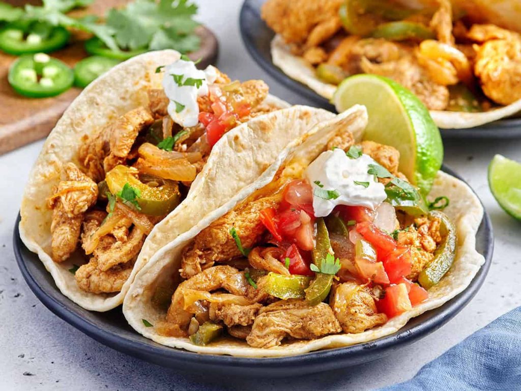 Stovetop Chicken Fajitas – Budget Bytes Side view of stovetop chicken fajitas with toppings.